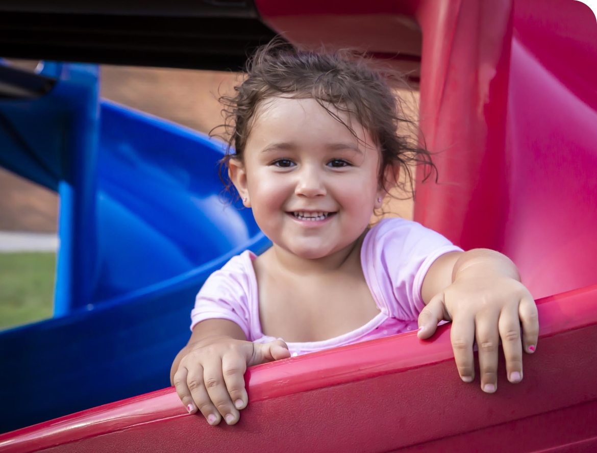 young girl playing on a slide